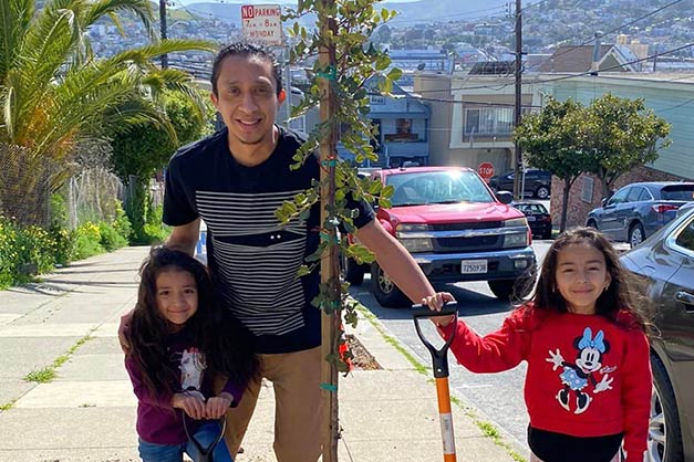 California ReLeaf Grantee - Climate Action Now Volunteers planting trees in San Francisco featuring a man and his two young daughters in front of a newly planted tree
